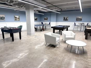The bell apartments game room with pool table shuffleboard ping pong and foosball.